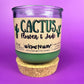 Recycled glass candle jar with printed label, green wax and tan cork base