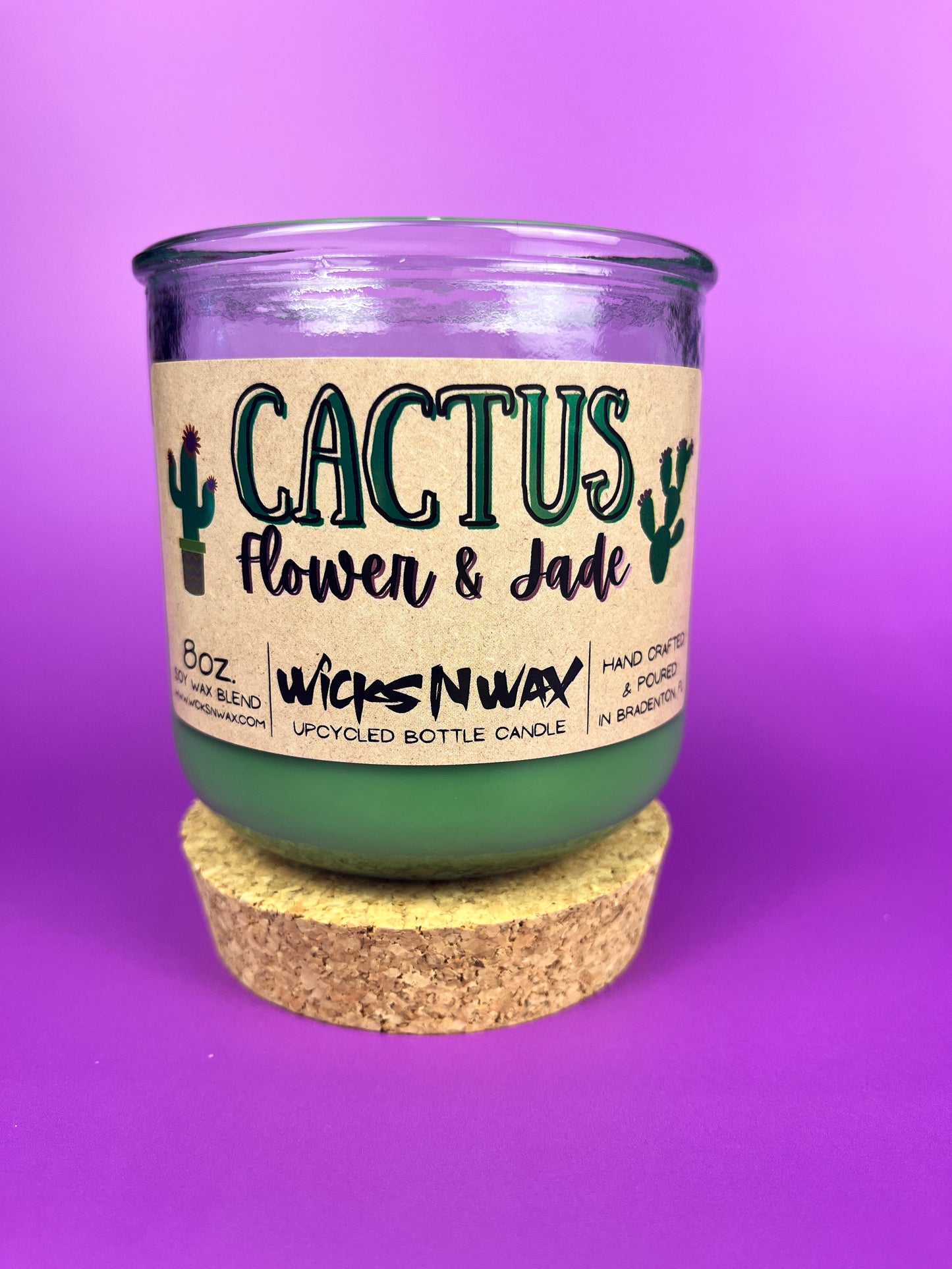 Recycled glass candle jar with printed label, green wax and tan cork base