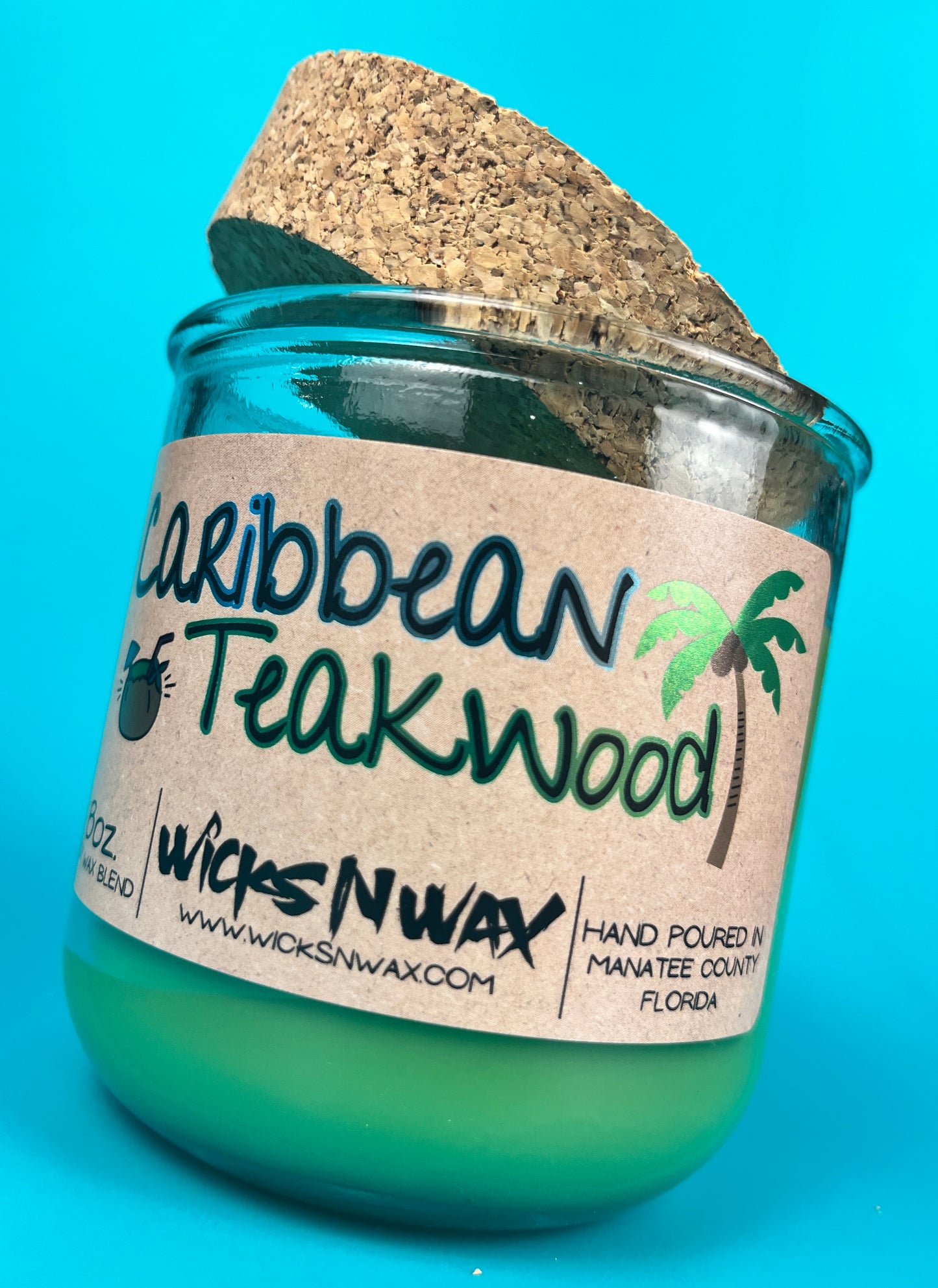 Recycled glass candle with green wax, speckled cork lid, Caribbean Teakwood label detail