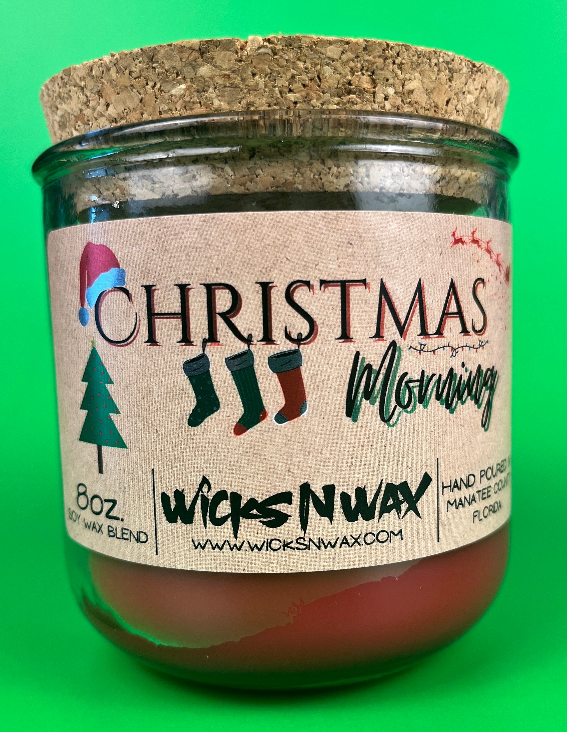 Christmas Morning recycled glass candle, front label with stockings and 'WicksNWax'
