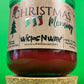 Christmas Morning recycled glass candle with side label and green jar, shown on cork base