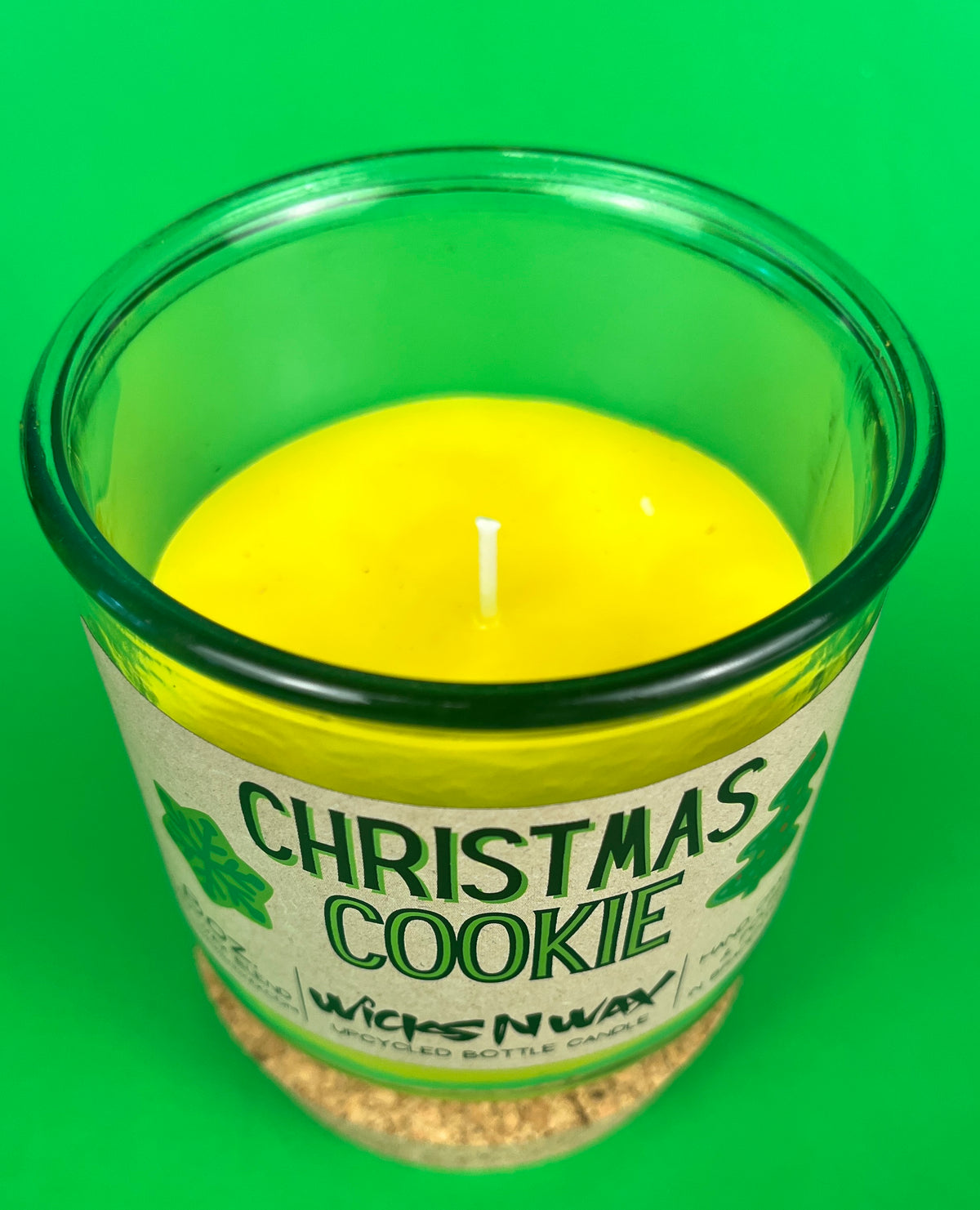 Christmas Cookie recycled-glass candle, open green jar showing yellow wax and wick