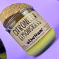 Recycled glass candle with green wax and “Citronella Lemongrass” label, angled view