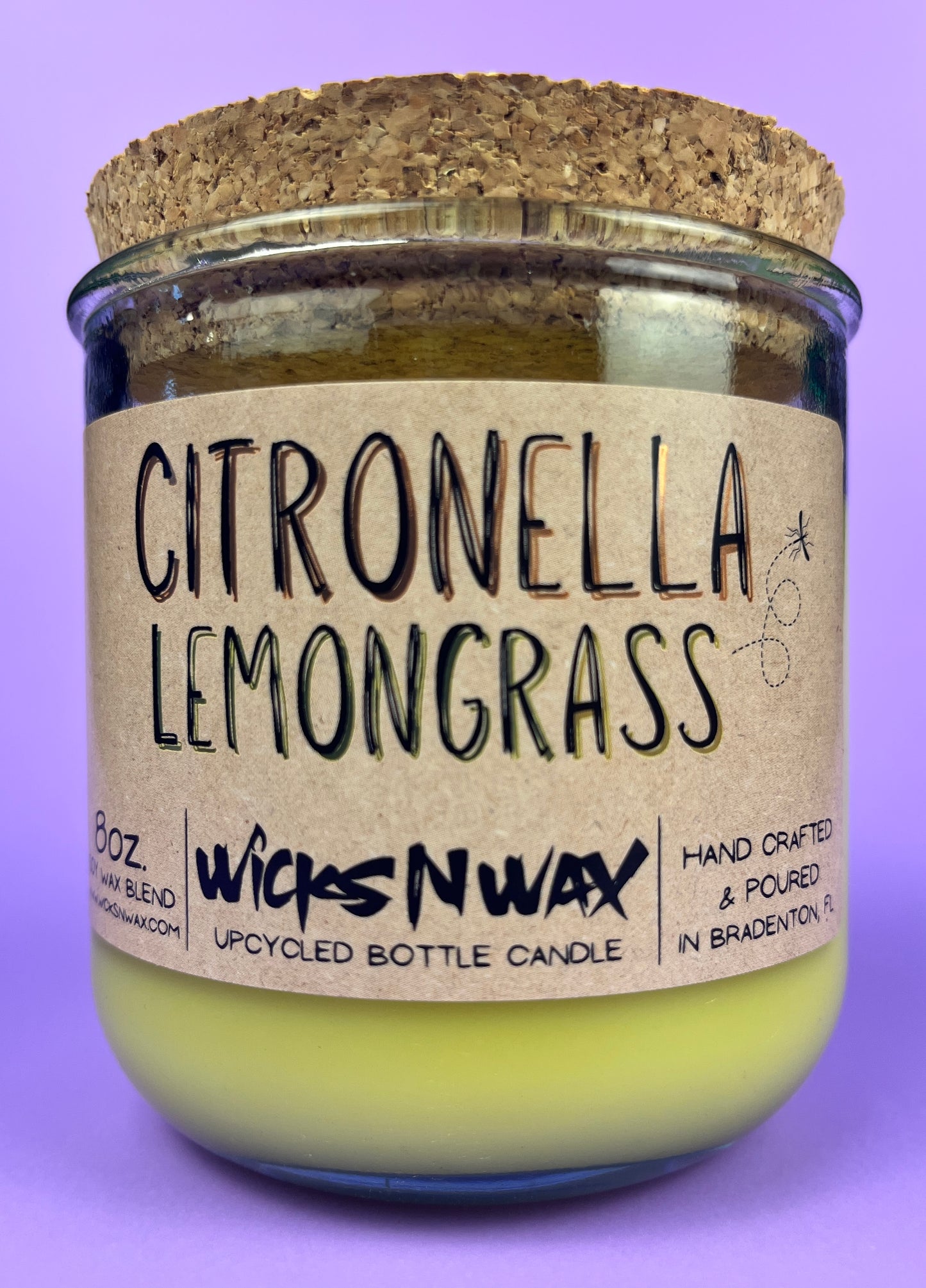 Recycled glass candle with green wax and “Citronella Lemongrass” label, cork lid
