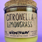 Recycled glass candle with green wax and “Citronella Lemongrass” label and cork lid