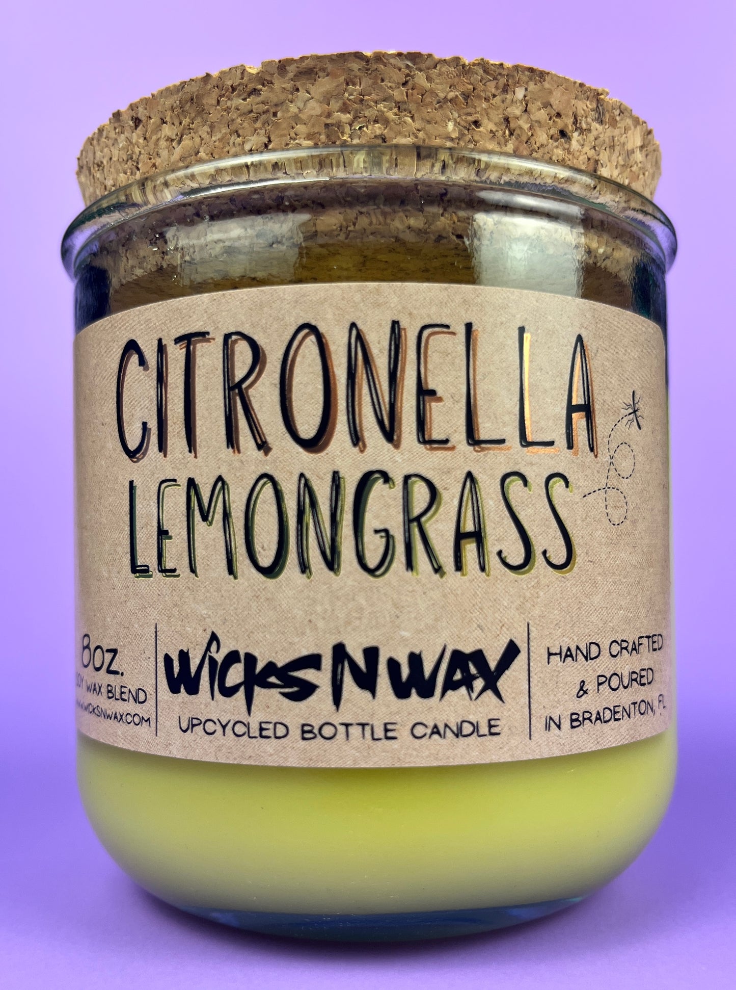 Recycled glass candle with green wax and “Citronella Lemongrass” label, cork base