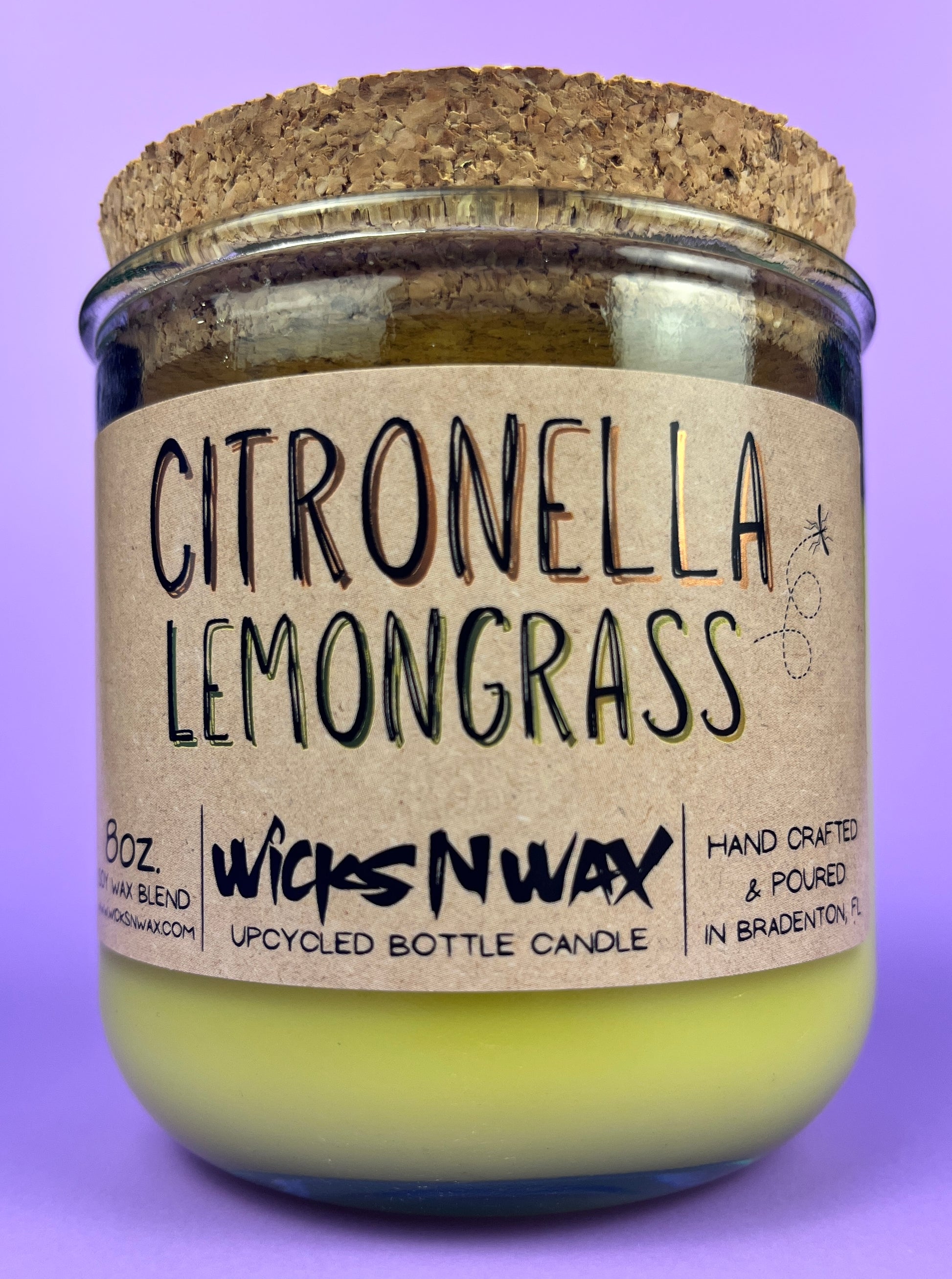 Recycled glass candle with green wax and “Citronella Lemongrass” label, cork base