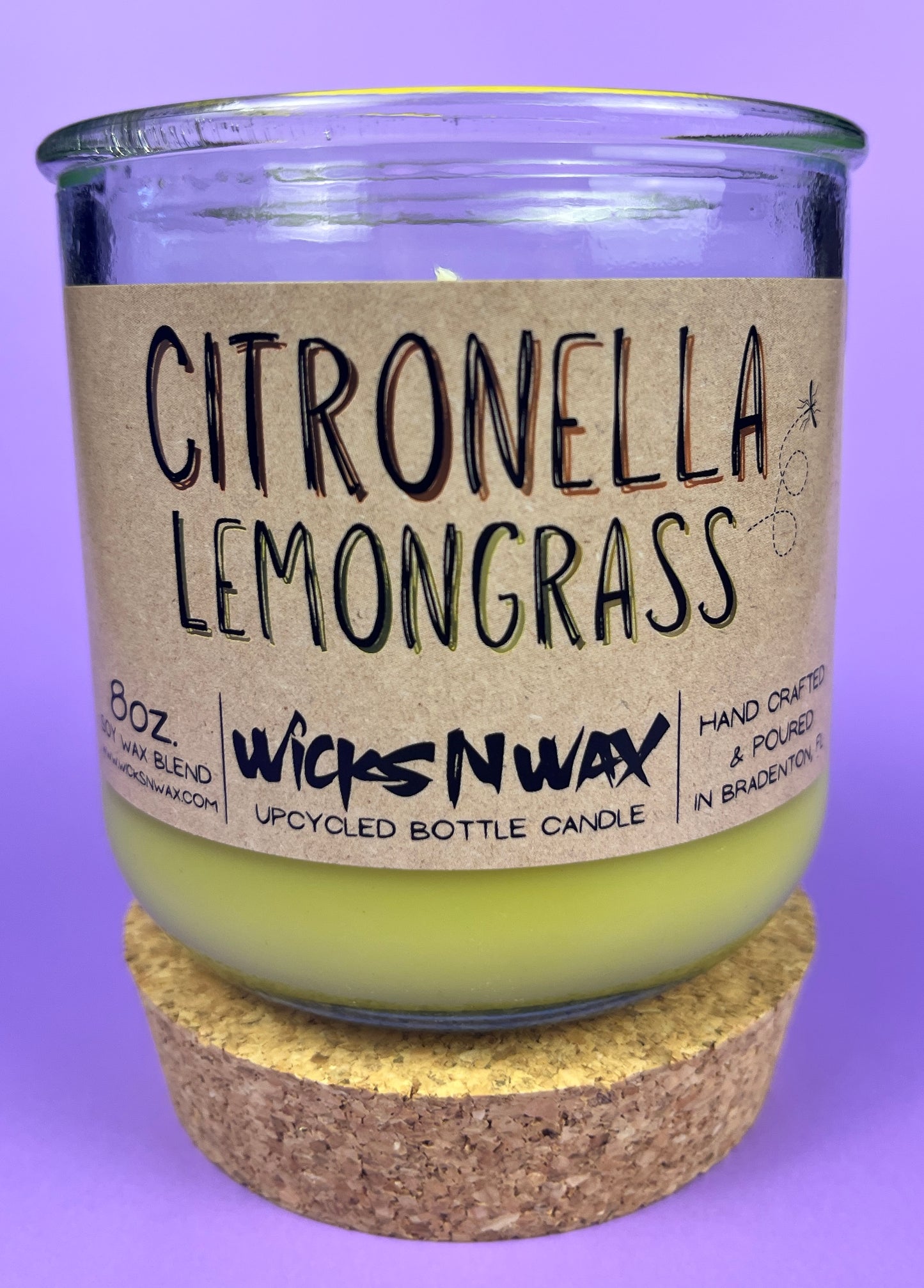 Recycled glass candle with green wax and “Citronella Lemongrass” label, cork base