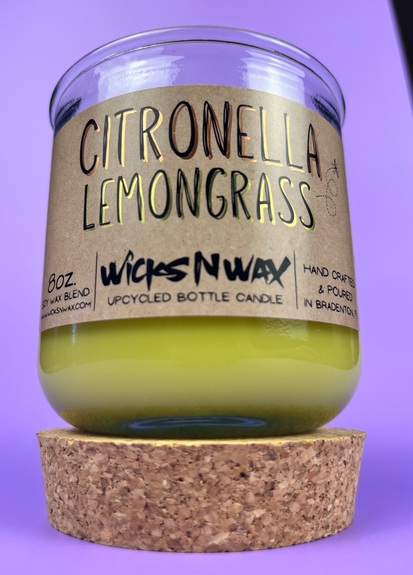 Recycled glass candle with green wax, cork lid, and “Citronella Lemongrass” label