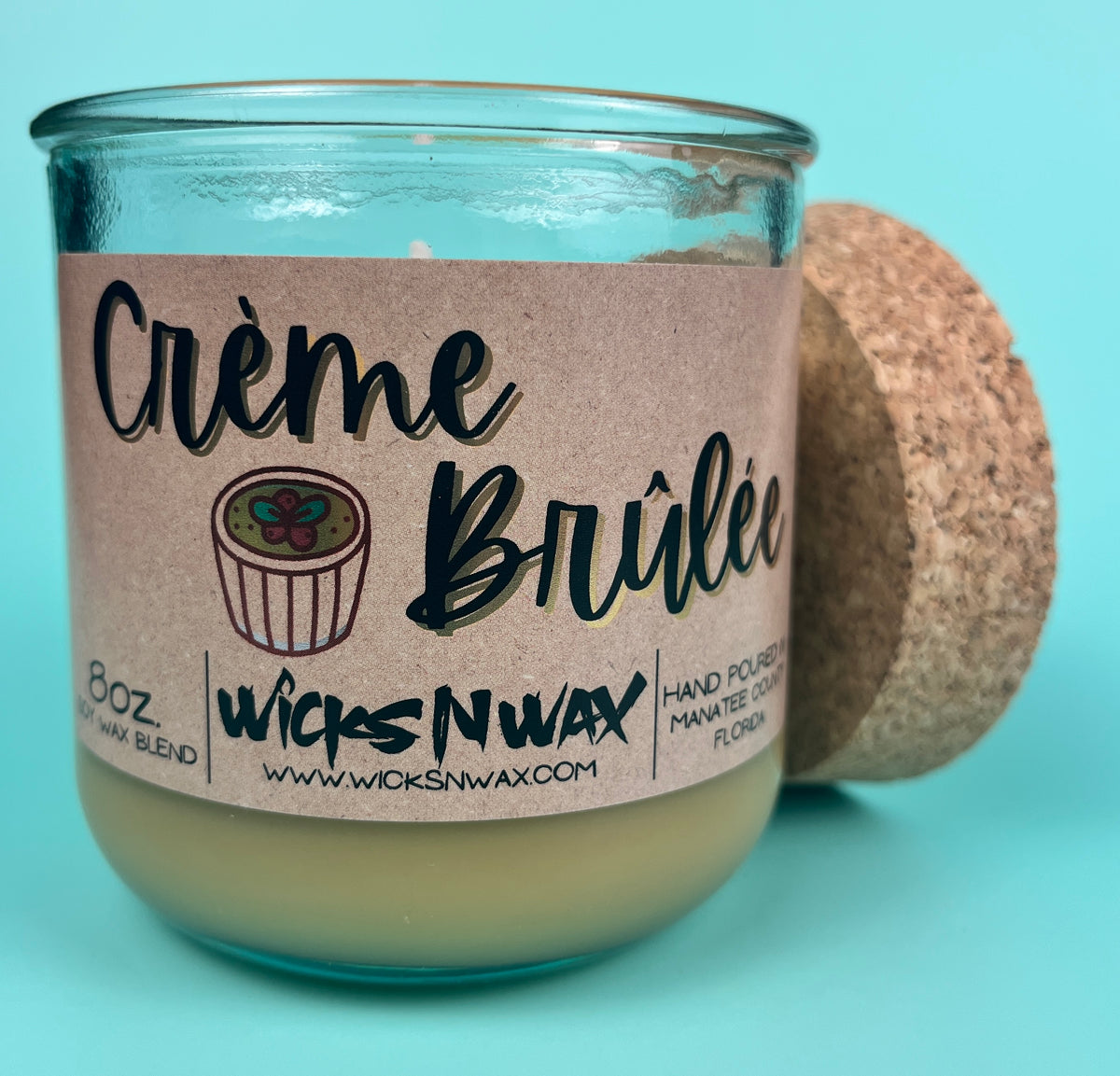 WicksNWax recycled glass candle in teal jar with Creme Brûlée label