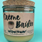 Recycled glass candle with kraft label and creamy wax; cork lid/stopper on top