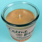 Recycled glass candle with creamy wax and wick centered inside the jar