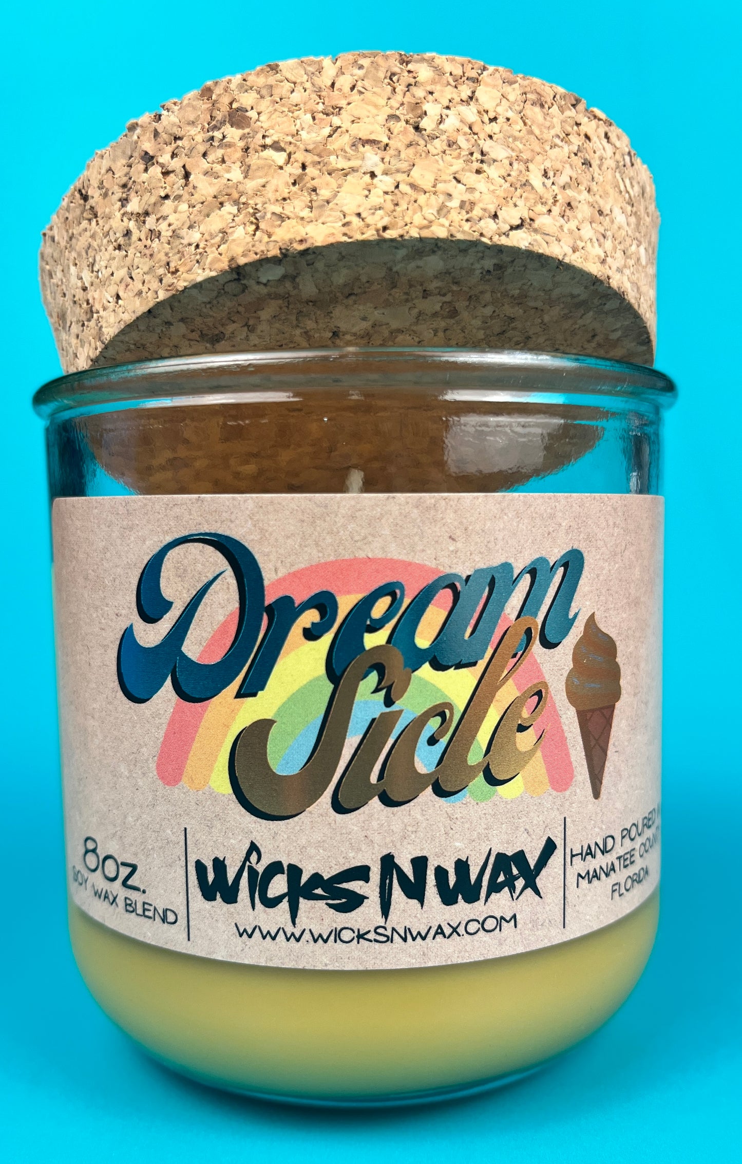 Recycled glass candle jar with cork base, yellow-green wax and printed label