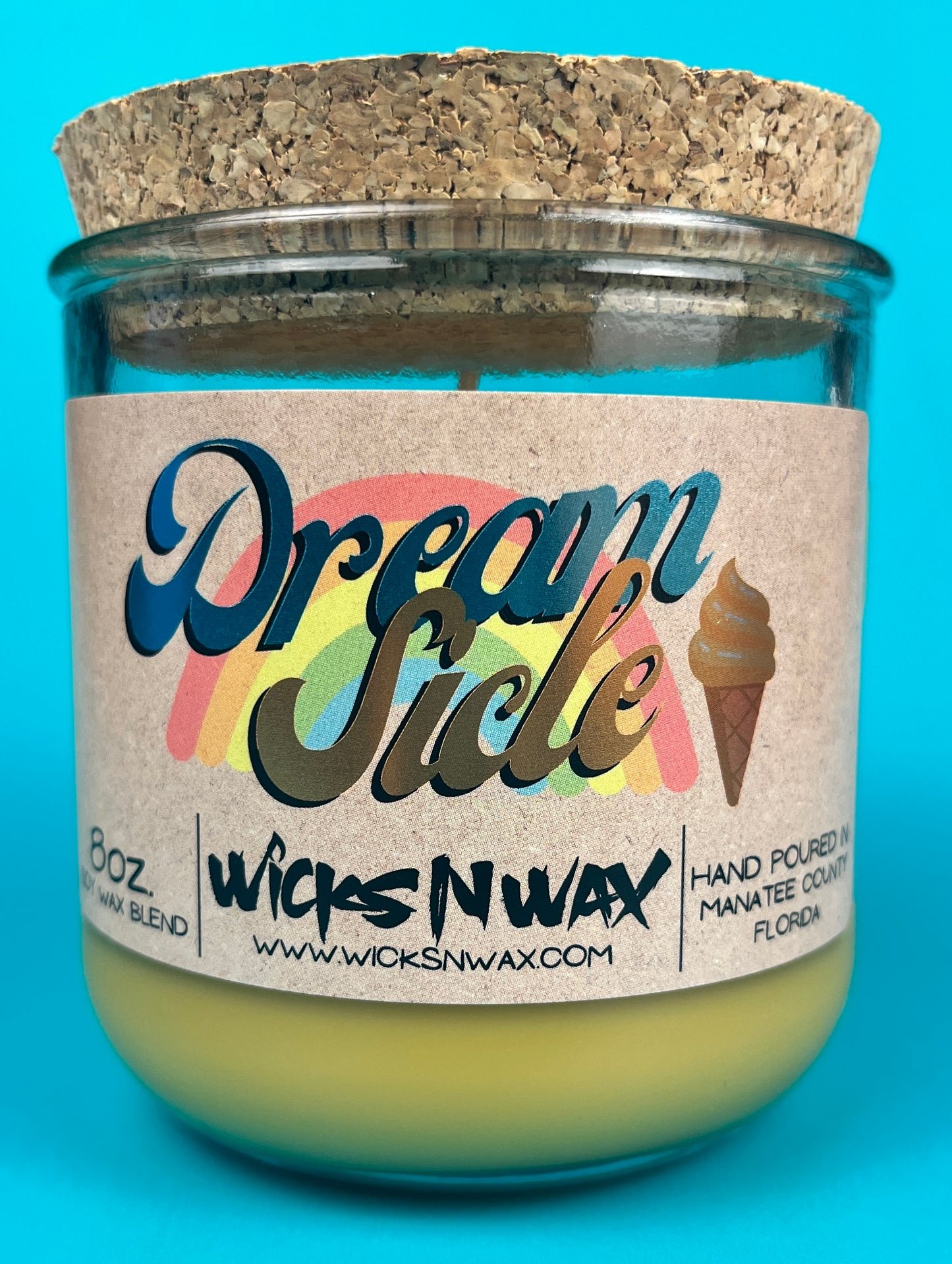 Recycled glass candle jar with cork base, yellow-green wax and printed label