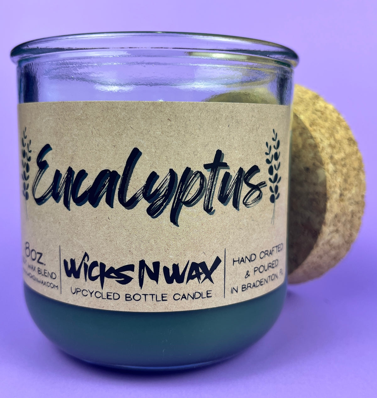 Eucalyptus recycled glass candle close-up, dark green wax in clear jar