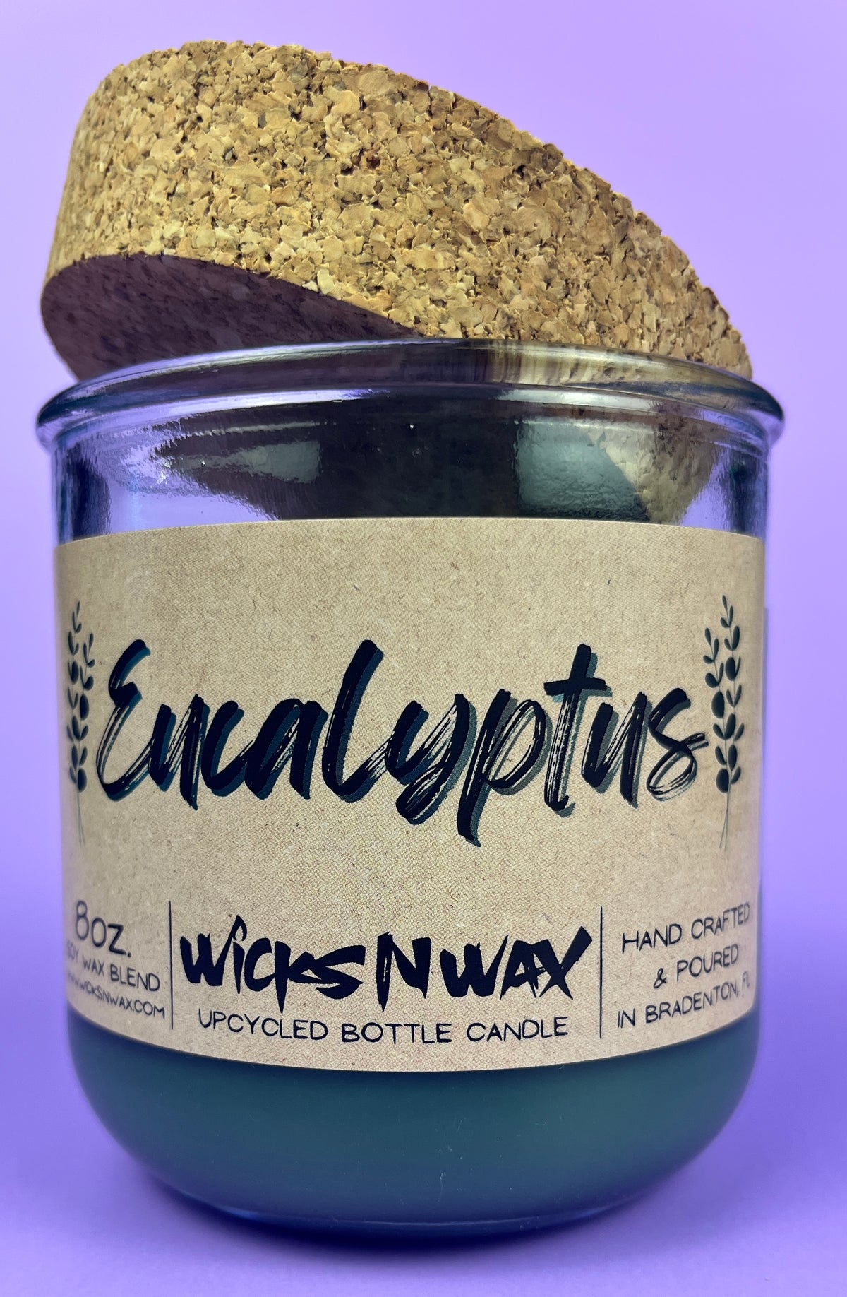 Eucalyptus recycled glass candle: dark green wax jar with cork lid on top
