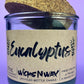 Eucalyptus recycled glass candle with cork lid; WicksNWax label on dark green glass