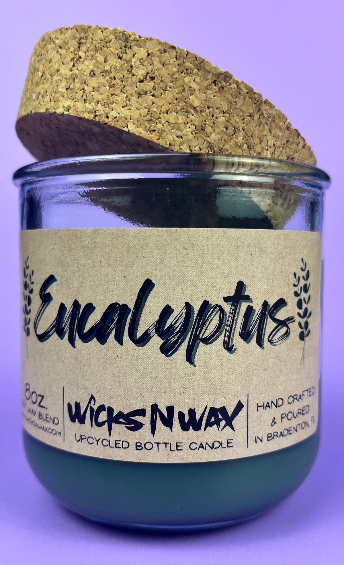 Eucalyptus recycled glass candle: dark green wax in clear jar with cork lid