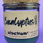 Eucalyptus recycled glass candle front view, dark green wax in clear jar with cork lid