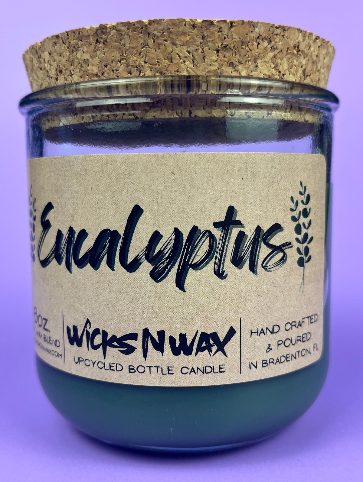 Eucalyptus recycled glass candle front view, dark green wax in clear jar with cork lid