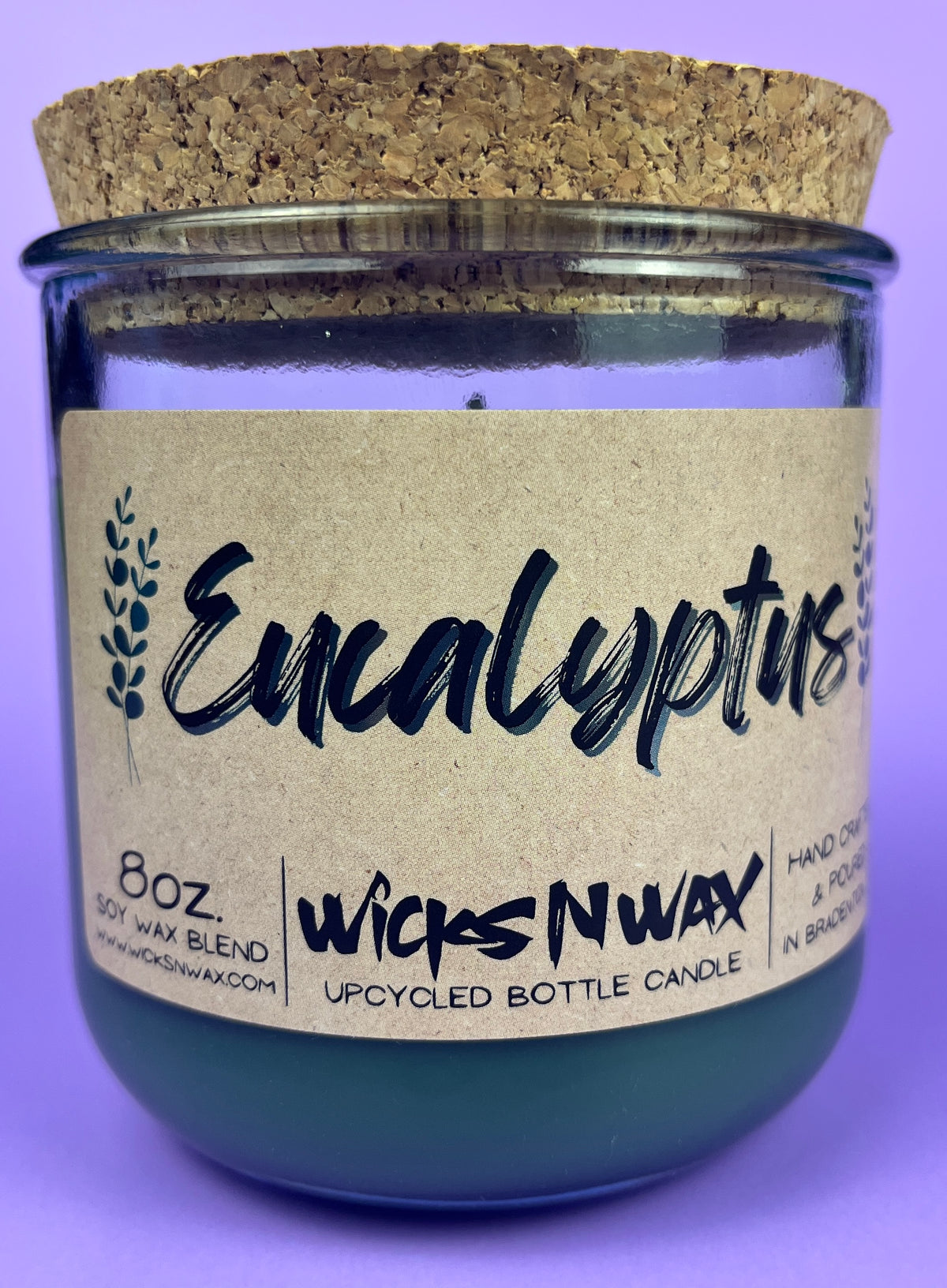 Eucalyptus recycled glass candle front view, dark green wax in clear jar with cork lid