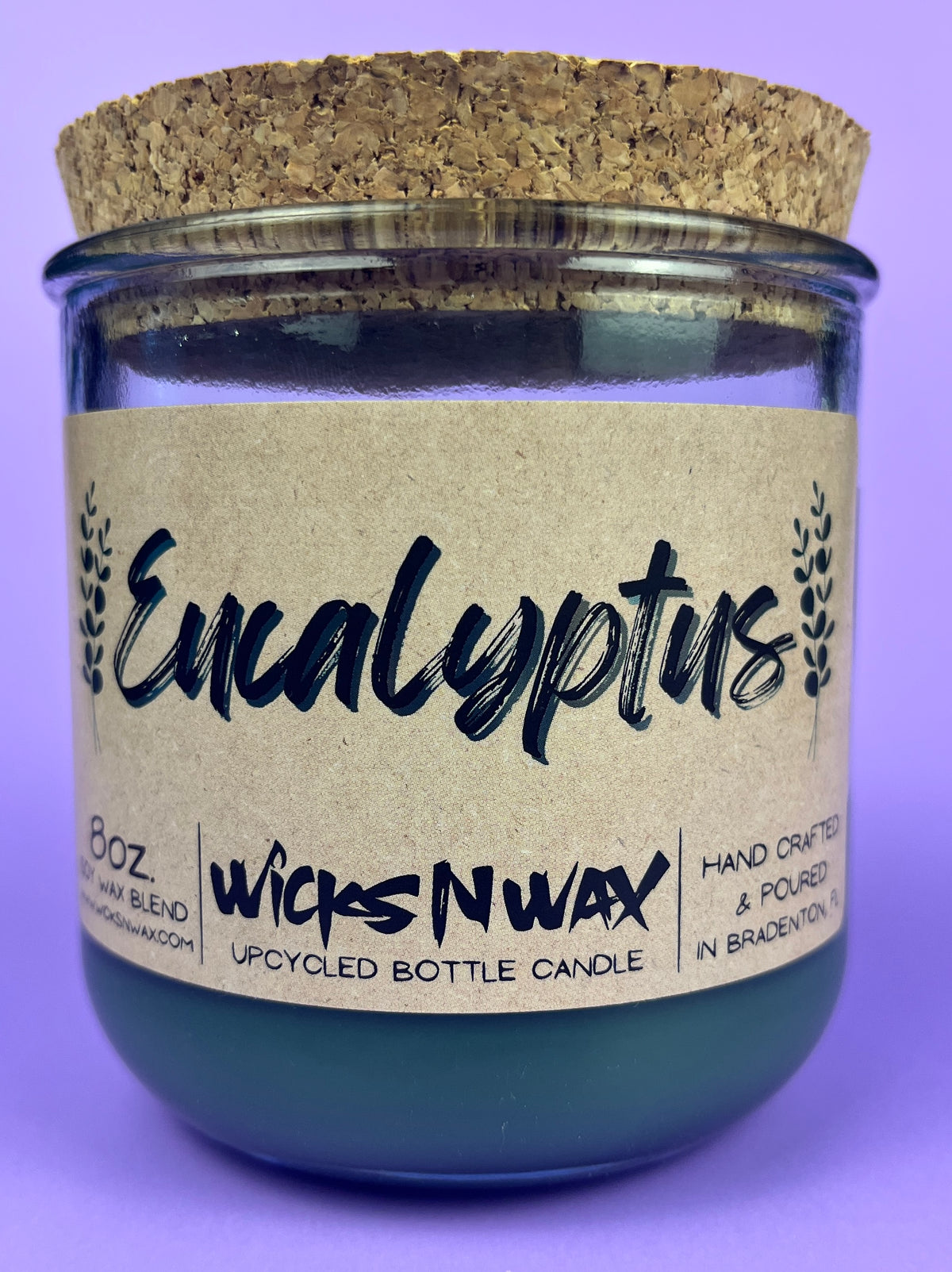 Eucalyptus recycled glass candle with cork lid; WicksNWax label in dark green glass