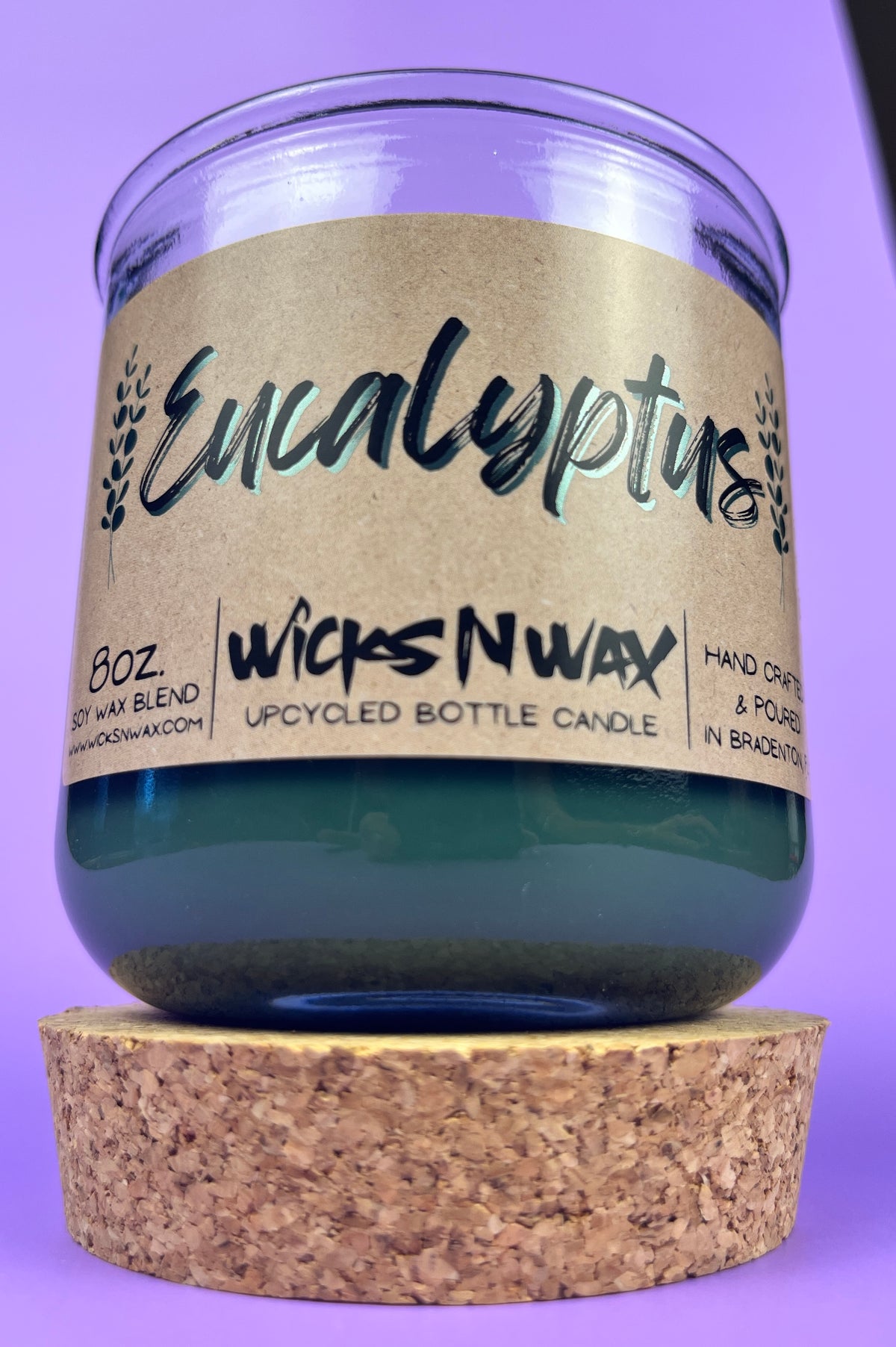 Eucalyptus recycled glass candle in clear jar with cork base and dark green wax