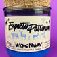 Blue glass candle jar with cream label and illustrated figures, cork lid behind