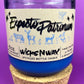 Blue glass candle jar on cork base with cream label and illustrated animal silhouettes