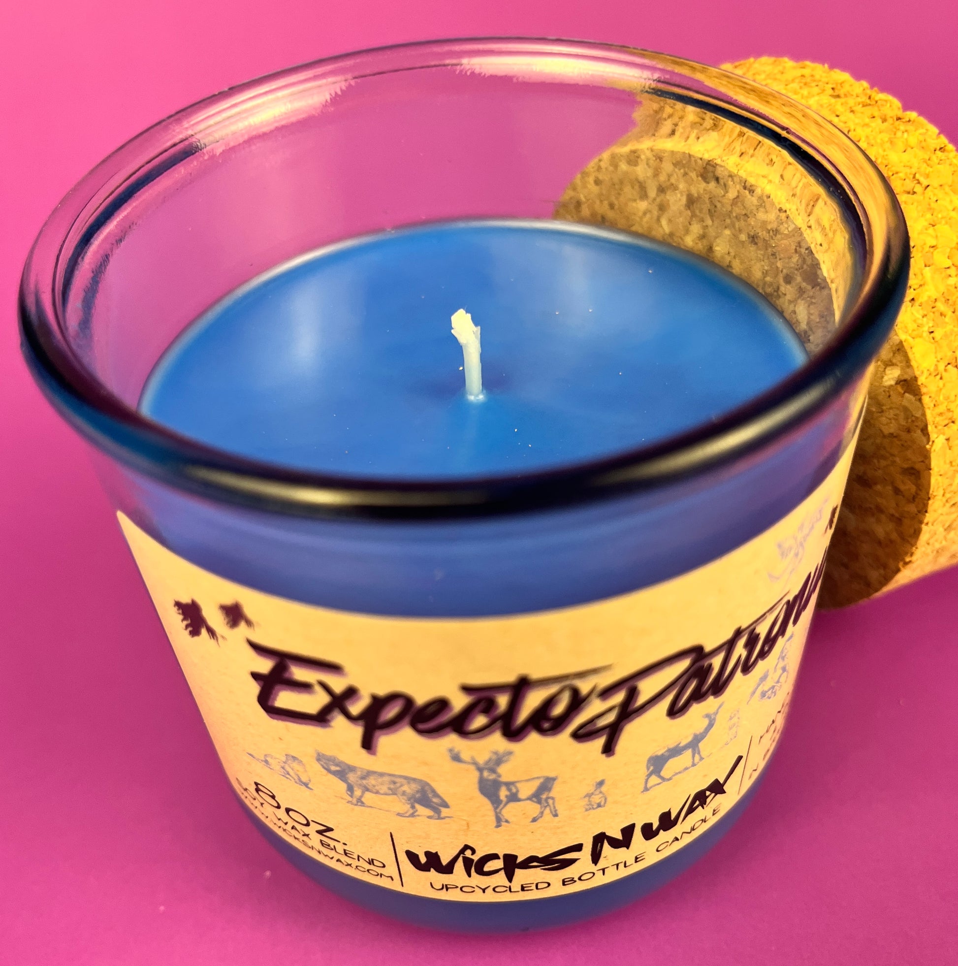 Recycled glass candle in blue jar with white wick and yellow graphic label