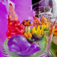 Garden gnome art candle jar showing red gnome and yellow, blue, and green wax details