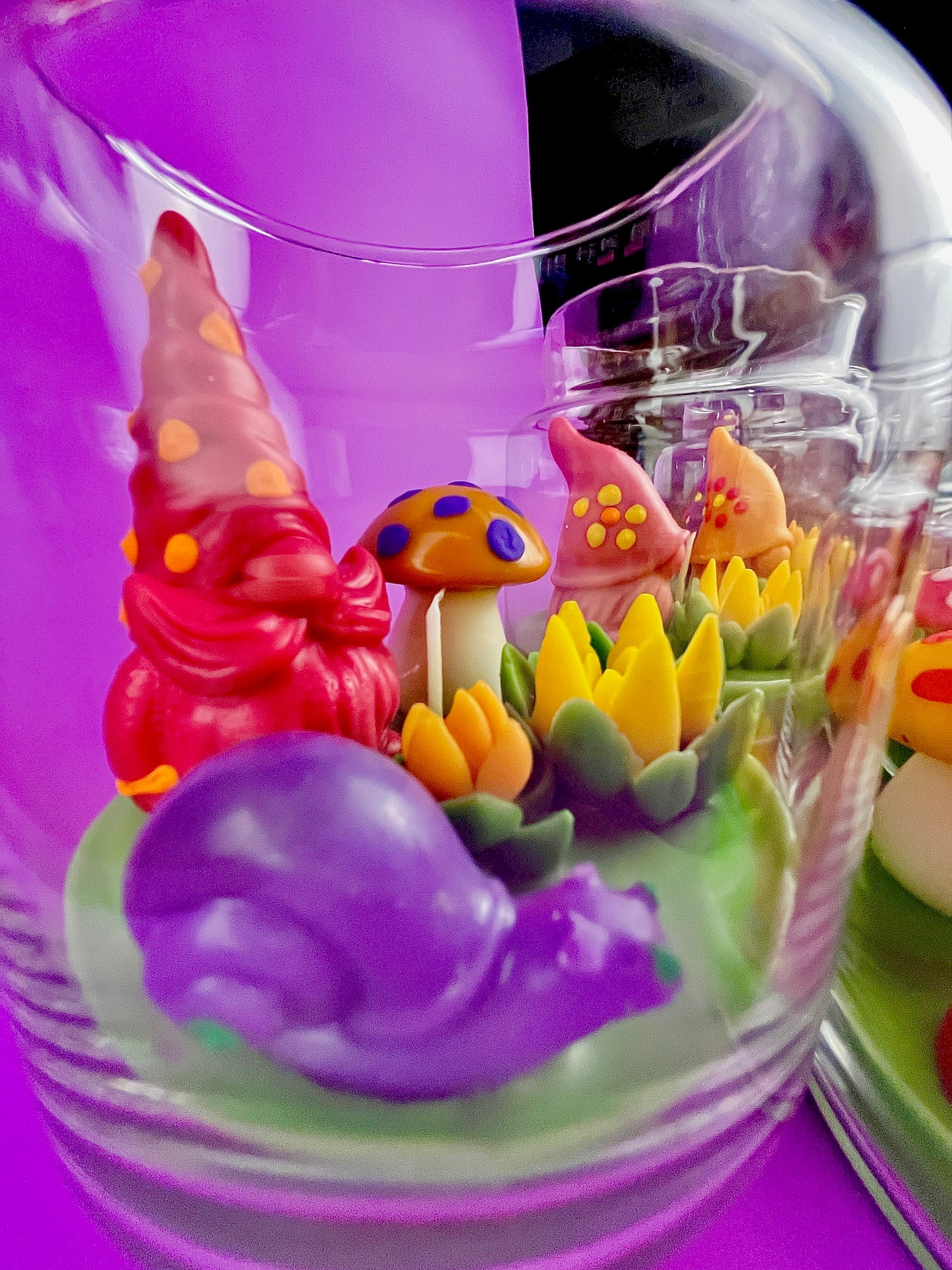 Garden gnome art candle jar showing red gnome and yellow, blue, and green wax details