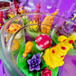 Garden gnome candle: colorful wax figures with red mushroom and flower details