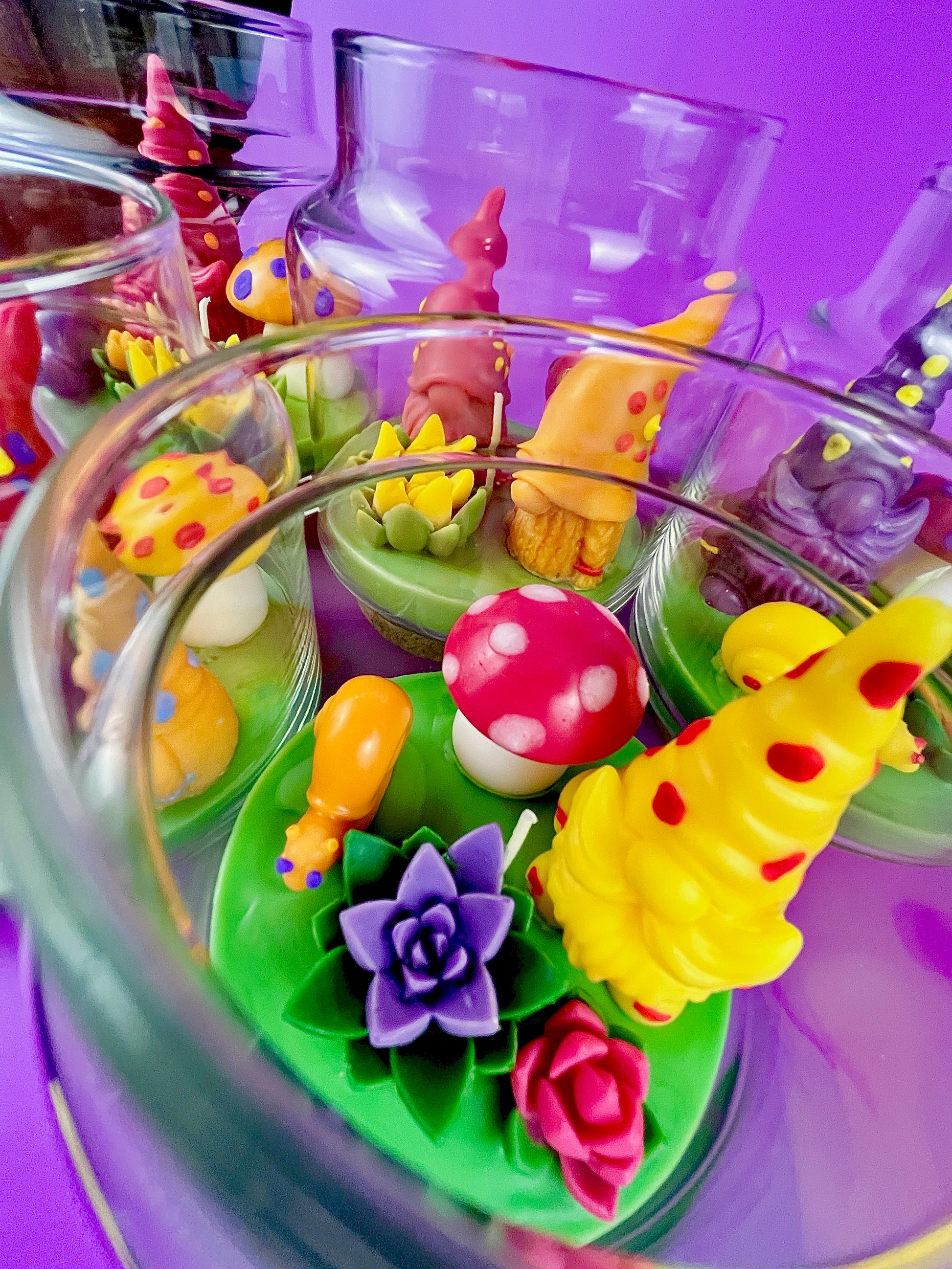 Garden gnome candle: colorful wax figures with red mushroom and flower details