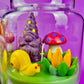 Garden gnome art candle jar with green wax base and purple, yellow, red gnome figures