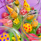 Garden gnome art candle jar filled with multicolored wax mushrooms, flowers, and cones