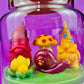 Garden gnome art candle in clear jar with green wax and gnome, mushroom, and flower figurines