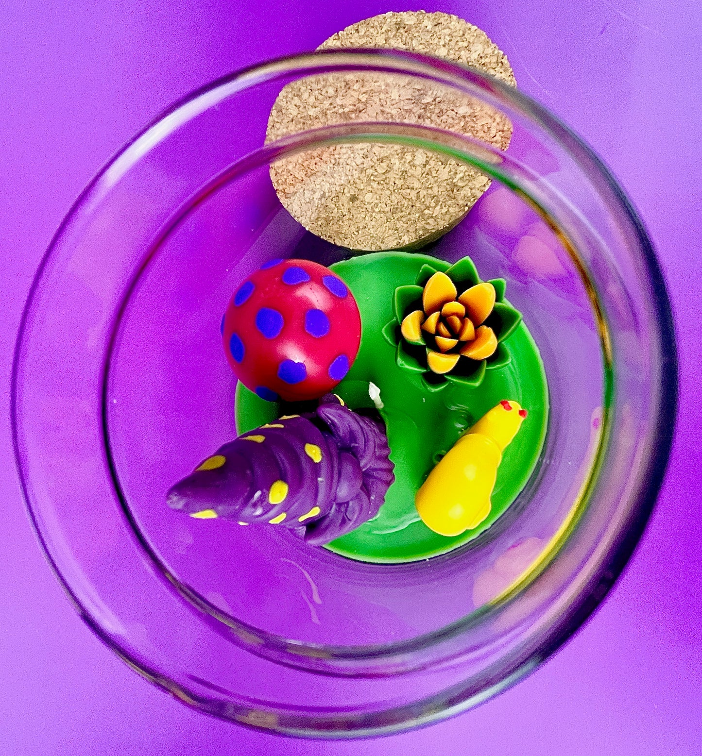 Garden gnome candle: top view with purple gnome, red mushroom and green wax pool