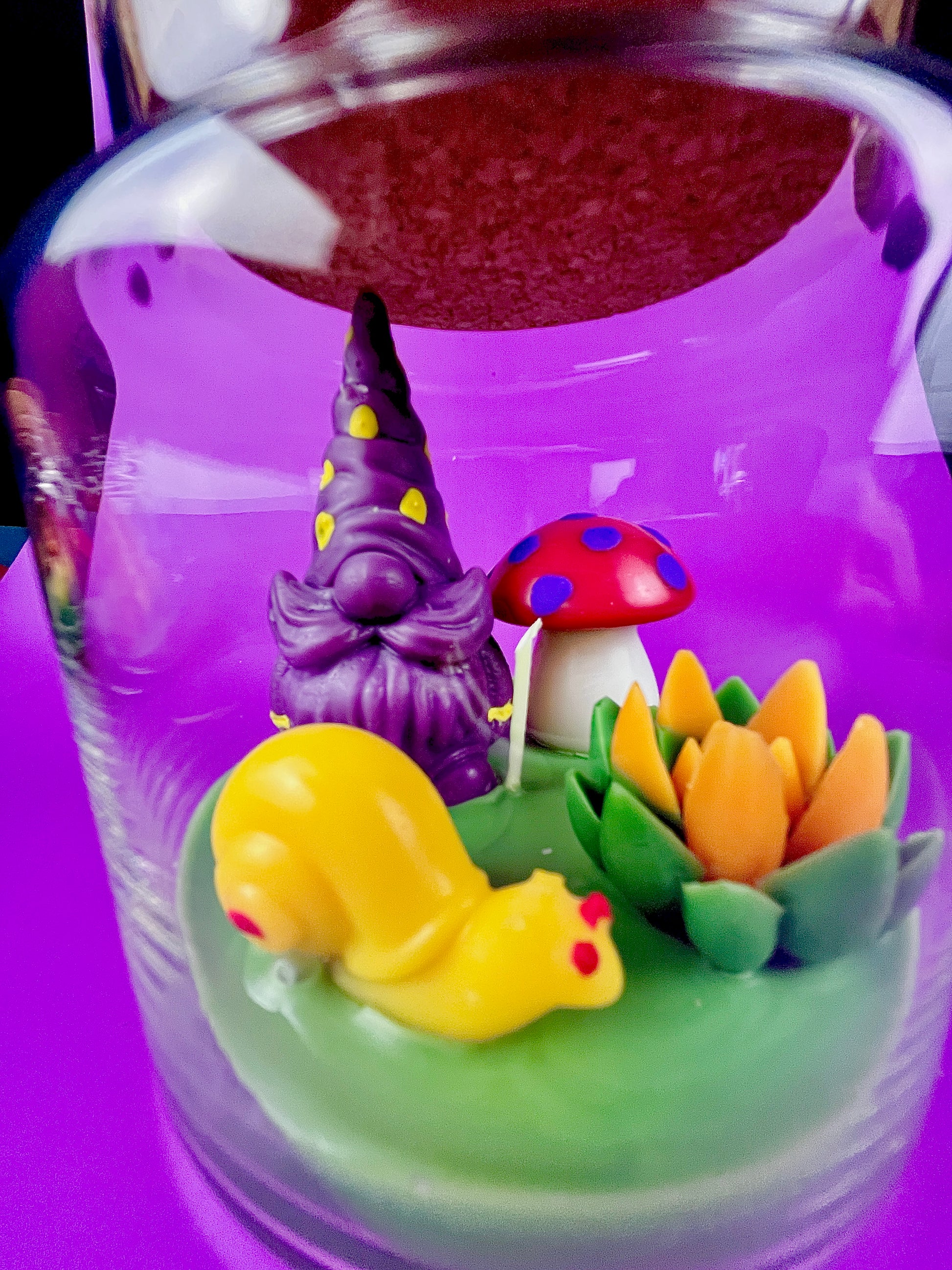 Garden gnome candle: purple gnome, red polka mushroom and green wax pond