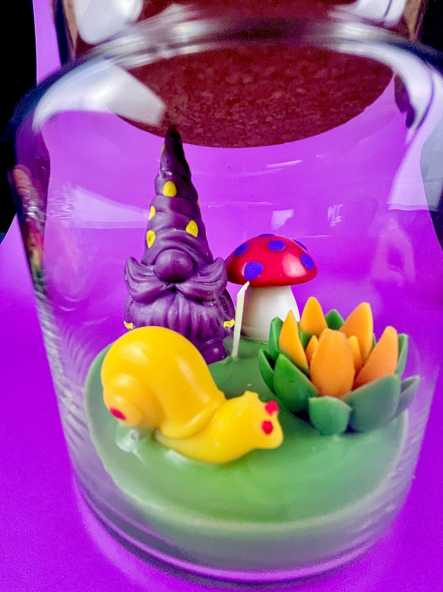 Garden gnome candle: purple gnome, red polka mushroom and colorful wax flowers