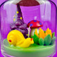 Garden gnome candle: purple gnome and yellow bird in green wax base
