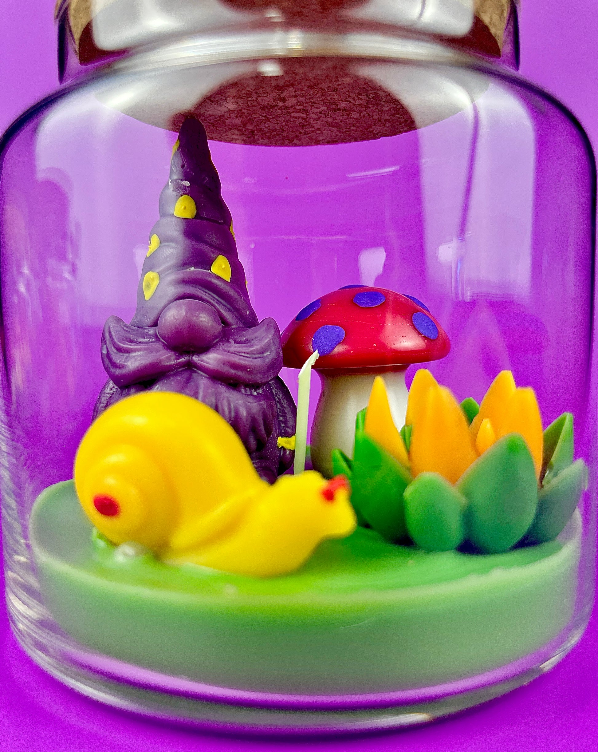 Garden gnome candle: purple gnome and yellow bird in green wax base