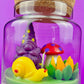 Garden gnome art candle in clear glass jar with yellow gnome, purple gnome, and garden flowers