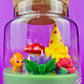 Garden gnome art candle in clear glass jar with green wax, mushroom, and flower figurines