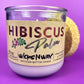 Recycled glass candle side view with cork lid and Hibiscus label on jar