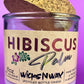 Recycled glass candle with cork lid tilted and Hibiscus label on glass jar