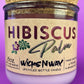 Recycled glass candle in purple glass jar with cork lid and Hibiscus label
