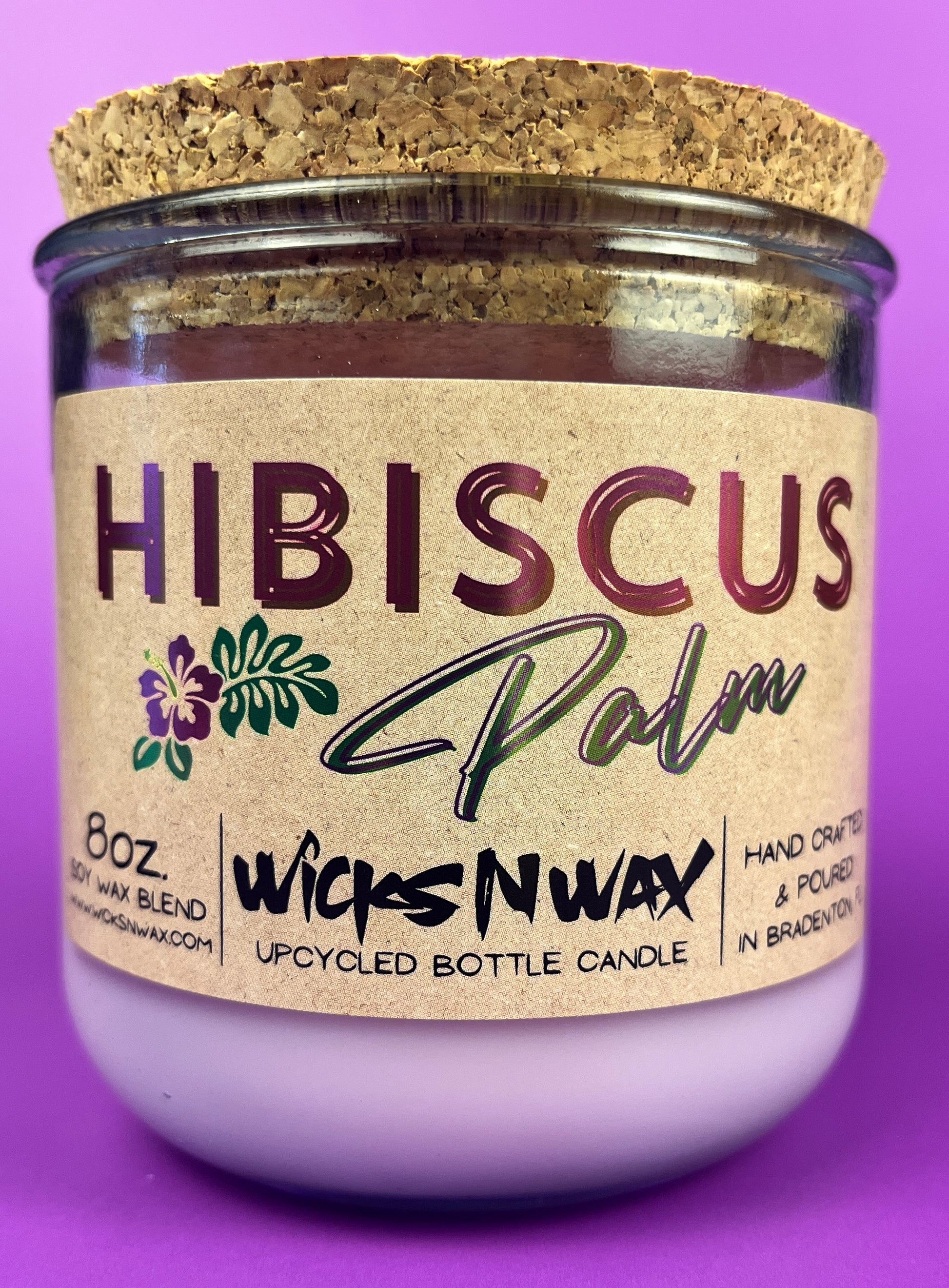 Recycled glass candle in purple glass jar with cork lid and Hibiscus label
