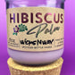 Recycled glass candle in purple jar on cork base with Hibiscus label