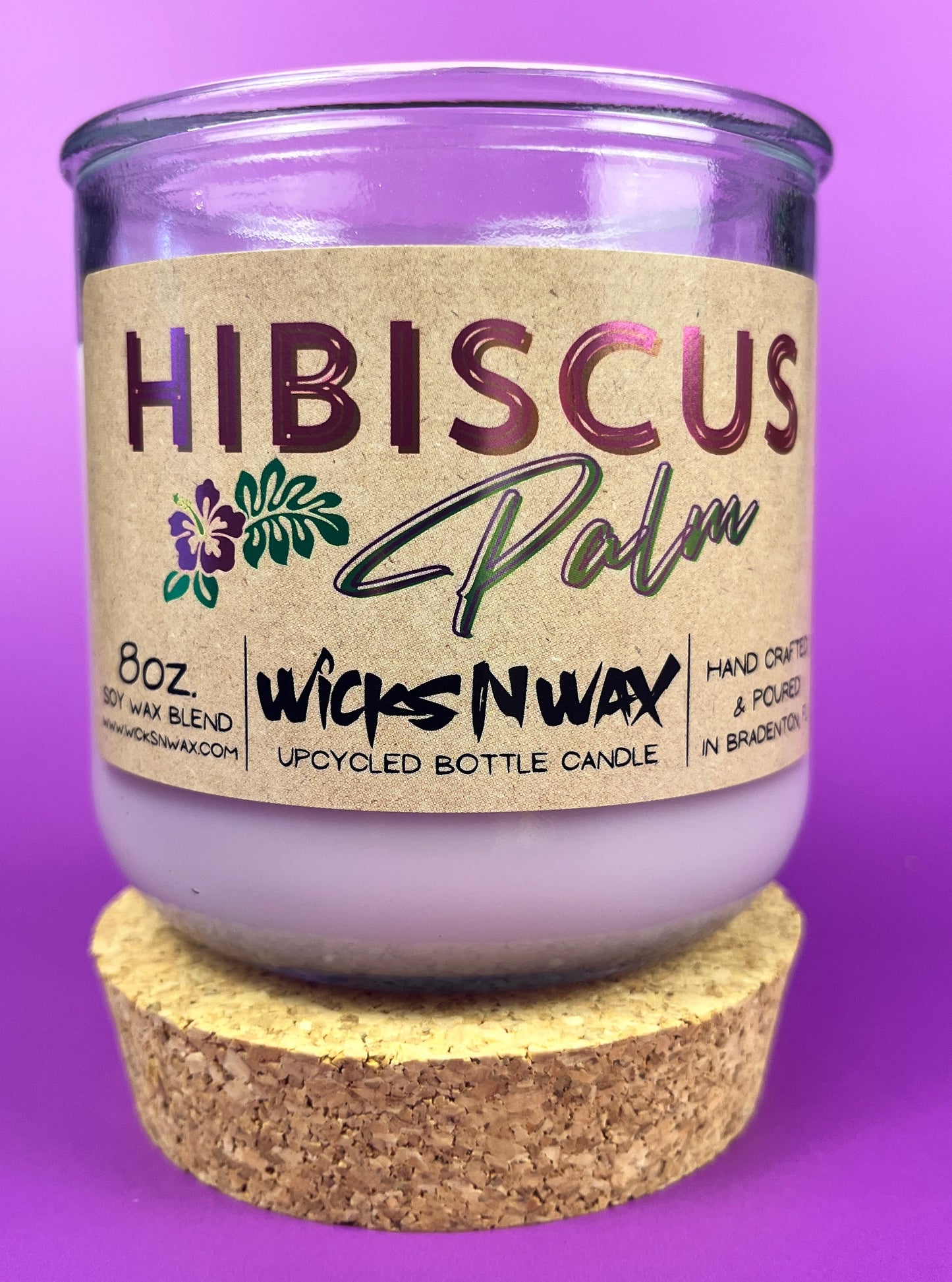 Recycled glass candle in purple jar on cork base with Hibiscus label